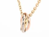 a close up of a gold necklace with two rings on a chain
