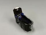 a bottle of ink sitting on top of a white surface