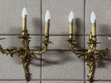 three candles that are on the wall next to each other