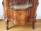 a wooden cabinet with a glass door on it