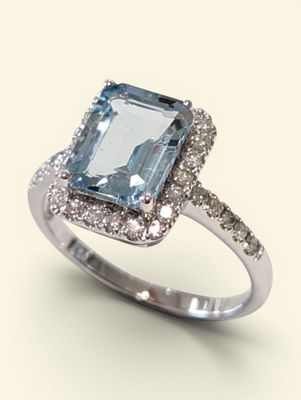 an image of a ring with a blue topaz stone surrounded by white diamonds