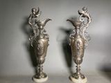 pair of antique silver vases with birds and flowers on them