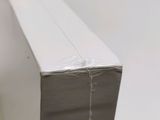 a close up of a piece of white paper on top of a table