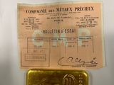 a piece of paper that has a gold bar on it