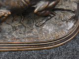 a bronze statue of a horse running on the ground