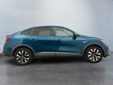 a blue car parked in a room with a gray floor