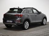 the rear end of a grey volkswagen suv parked on a checkered floor