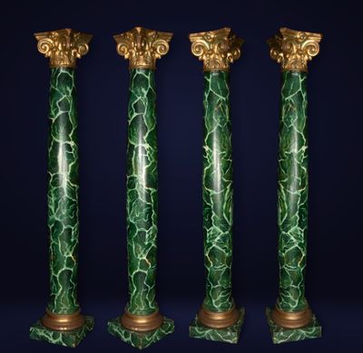 a set of four green marble columns with gold detailing