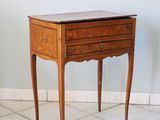 a small wooden table with a drawer on top of it