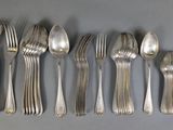 five spoons and six spoons sitting on a table