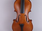 an old violin sitting on top of a white surface