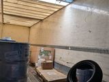 a room that has a lot of boxes and a trash can in it
