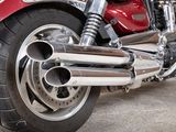 a close up of a red motorcycle parked in a garage