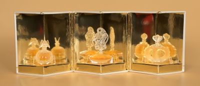 three glass figurines that are sitting on a table
