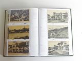 an open book with pictures of a town on it
