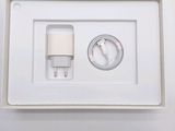 a white box with a charger and a cable in it