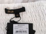 the label of a white dress is attached to a white shirt
