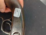 a person holding a gun with a tag on it