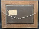 an old picture frame with a piece of paper attached to it
