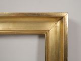 an image of a gold frame with a white wall in the background