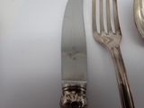 a knife, fork and spoon sitting on a table