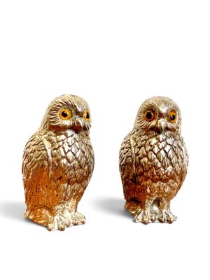 two figurines of owls sitting next to each other