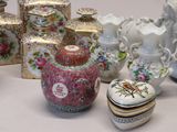many different types of vases and containers on the table