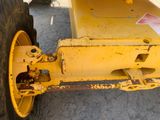 a close up of a yellow tractor wheel with a red sticker on it