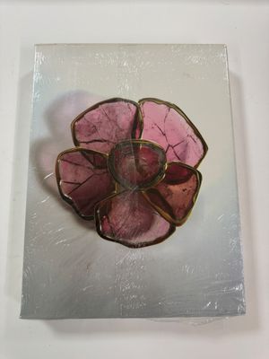 a picture of a pink flower on a piece of glass