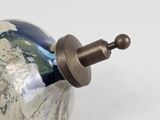 a silver vase with a blue and white design on it