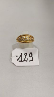 un gros plan d'une bague en or sur une étiquette de prix