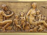 une image représentant un relief en bronze d'une famille avec un oiseau