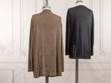 pair of men ' s sweaters on a mannequin stand in front of a white wall