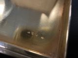 a close up of a metal tray with a metal lid