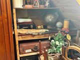 a room with a chair, a cabinet, and a table in it