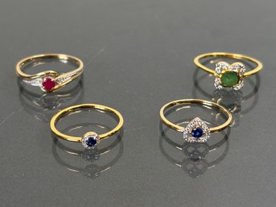four different colored stones are arranged in a row on a table