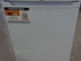 an image of a white refrigerator in a warehouse