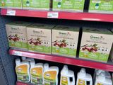 many bottles of juice on the shelves in the store