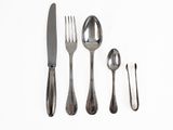 a knife, fork, spoon, and spoon rest on a white surface