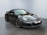 porsche 911 carros in a showroom with a black car in the background