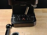 an image of a coffee maker on a wooden table
