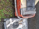 a pile of tools sitting on the ground next to a trash can