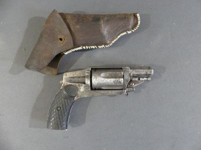 a gun and a knife on a table next to each other