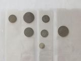 five different types of coins in a plastic container