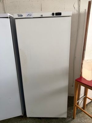 two white refrigerators next to each other in a room