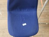 a blue chair that is sitting on a hard wood floor