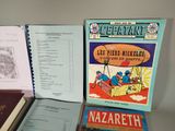 several books are sitting on a table next to each other