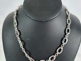 a close up of a necklace on a mannequin display