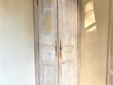 a white cabinet in the corner of a room