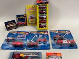 five cars and a box of other toys on the table